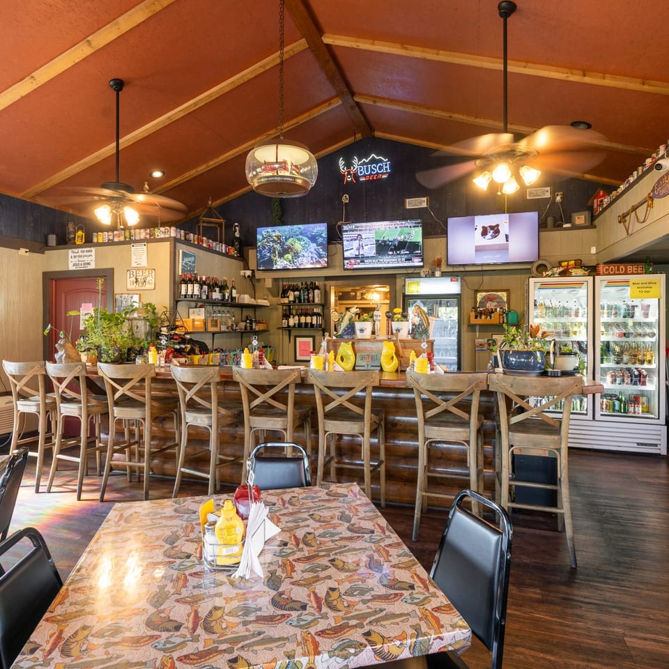 Angler's bar with wooden stools and televisions.