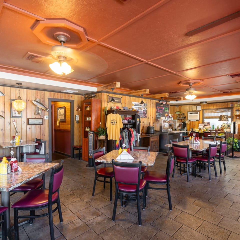 Angler's dining room with wood-paneled walls and tables.