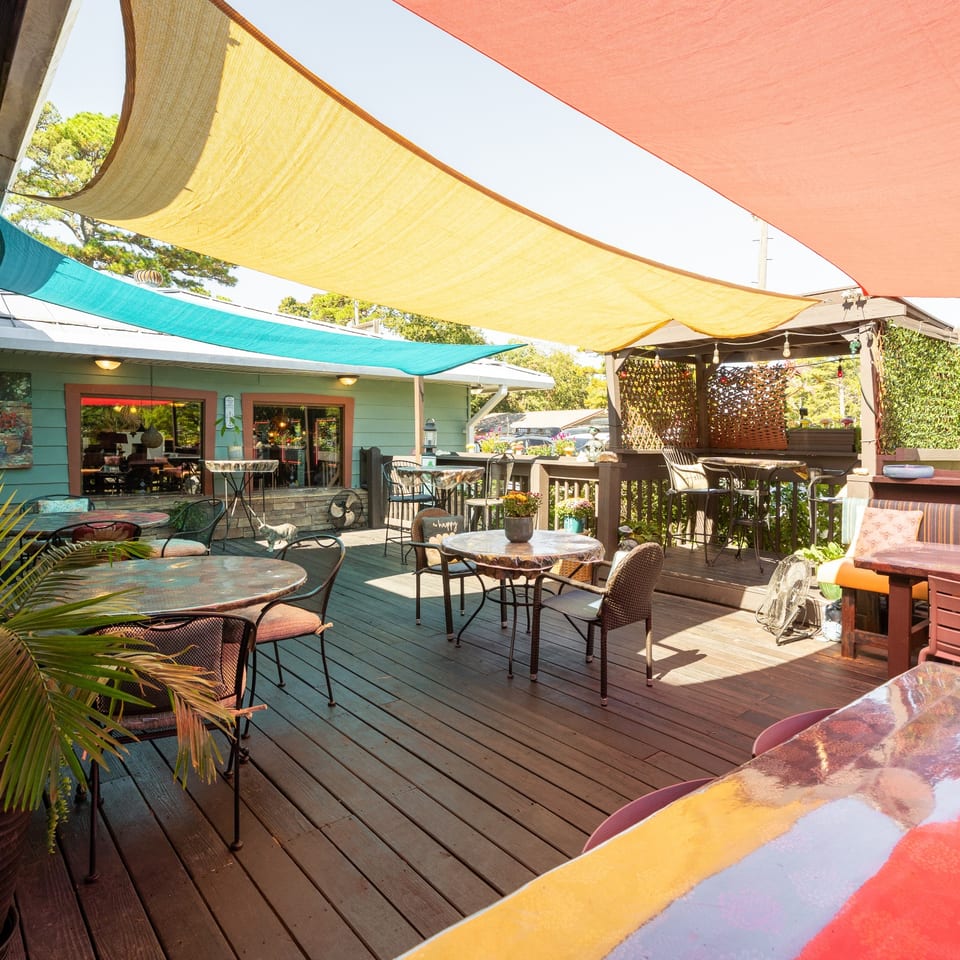 Angler's outdoor patio beneath colorful shade sails.