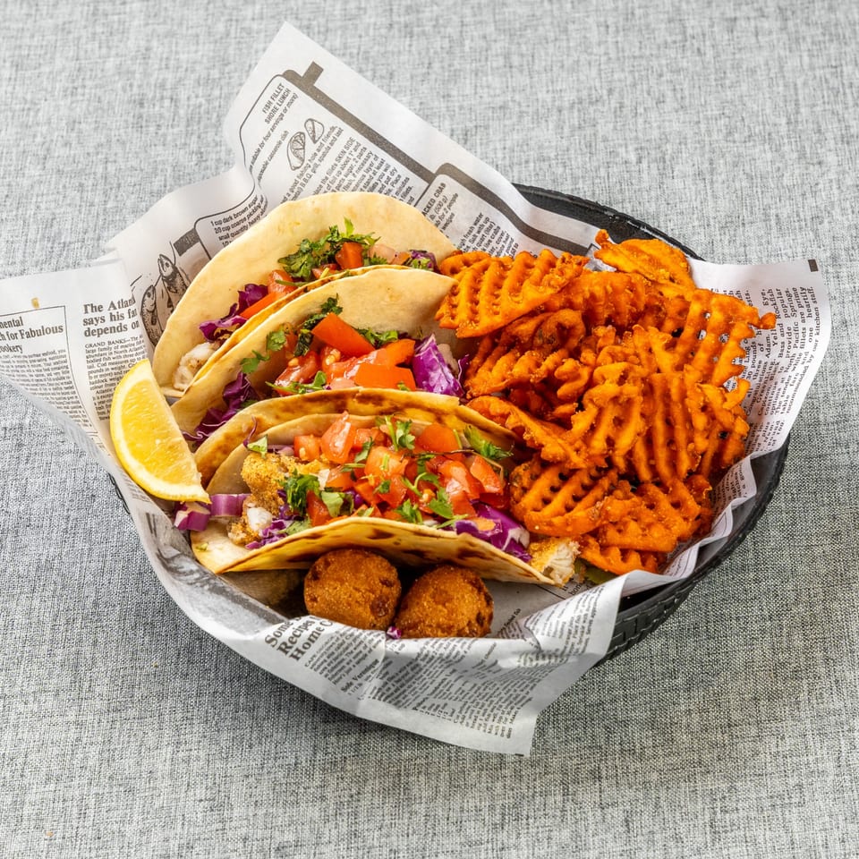 Catfish tacos with waffle fries and hushpuppies.